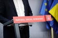 A politician is holding a press conference at a desk of the Social Democratic Party Partidul Social Democrat, PSD Royalty Free Stock Photo