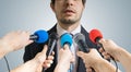 Politician is talking ang giving interview to reporters. Many microphones recording him. Royalty Free Stock Photo