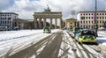 Police vehicles in wintry Berlin at the Brandenburg Gate, Germany