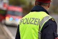 Police officer from behind with fire service vehicle in Upper Austria, Austria, Europe