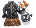 Polka dot brown dress, windbreaker jacket, bag and chelsea shoes on a light background, top view. Women`s clothing fashion. Flat