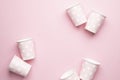 Polka dot disposable paper cups on pink background with copyspace Royalty Free Stock Photo