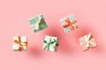 Polka dot pattern gift box with ribbon falling on pink background, levitation Royalty Free Stock Photo