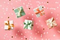 Polka dot pattern gift box with ribbon falling on pink background, levitation