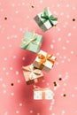 Polka dot pattern gift box with ribbon falling on pink background Royalty Free Stock Photo