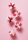 Polka dot pattern red gift box with ribbon falling on pink background Royalty Free Stock Photo