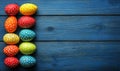 Polka-dotted eggs in various colors arranged neatly on a blue surface Royalty Free Stock Photo