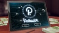 Polkadot cryptocurrency logo on the pc tablet display. Neon bright blockchain symbol