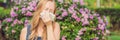 Pollen allergy concept. Young woman is going to sneeze. Flowering trees in background BANNER, long format Royalty Free Stock Photo