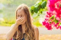 Pollen allergy concept. Young woman is going to sneeze. Flowering trees in background Royalty Free Stock Photo