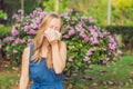 Pollen allergy concept. Young woman is going to sneeze. Flowering trees in background Royalty Free Stock Photo