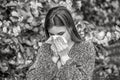 Pollen allergy, girl sneezing. Allergy, sneezing, spring. Woman sneezing in front of blooming tree. Black and white Royalty Free Stock Photo