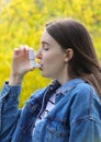 Teenager girl using asthma inhaler in park Royalty Free Stock Photo