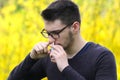 Pollen allergy,  Teenager Boy using nose inhaler in park Royalty Free Stock Photo