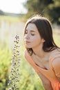 Pollen season. Summer allergies are caused by pollen from grass and Flowers. Young woman smells the blooming Flowers