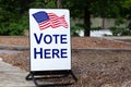 Polling place sign encouraging citizens to vote here at the local school.