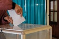 Polling station. Closeup of female hands with the bulletin. Nationwide voting, elections