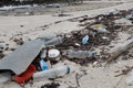 A polluted beach on Ko Samui, Thailand, littered with plastic bottles, food containers, and various types of debris. Royalty Free Stock Photo