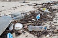 A polluted beach on Ko Samui, Thailand, littered with plastic bottles, food containers, and various types of debris Royalty Free Stock Photo