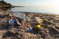 Polluted Beach With Plastic Garbage Lying On Sand Near Water Royalty Free Stock Photo