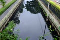 Polluted canal and dirty sewer in an urban area in Bangkok thailand. Polluted water and garbage are serious subject of Thailand Royalty Free Stock Photo