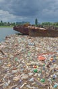 Polluted river bank full of garbage Royalty Free Stock Photo