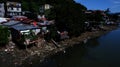 Polluted and stinking huge river teeming with shanty dwellers in a suburban community