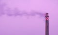 Polluting factory chimney with sunrise sky on the background Royalty Free Stock Photo