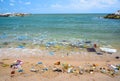 Pollution on the beach of tropical sea. Royalty Free Stock Photo