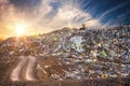 Pollution concept. Garbage pile in trash dump or landfill at sunset