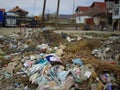 Pollution, damage and abandoned village with trash, rubble and recycling for climate change crisis. Landfill, community