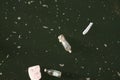 Garbage floating in the water of a lake, closeup of photo