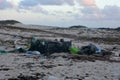 Pollution and Litter Scattered Across A Beach