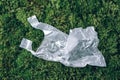 Pollution problem concept. Disposable plastic bag on green moss, grass background. Top view. Copy space. Environmental Royalty Free Stock Photo