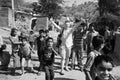 India: Polish photo reporter in the slums of Vijaynagar surrounded by children