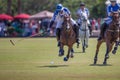 Polo player swings at ball