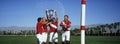 Polo team celebrating with trophy on field Royalty Free Stock Photo