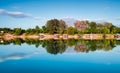 Poloj by the river Sava near Slavonski Brod, Croatia with fishing huts by the water and a forest-covered shore during a sunny