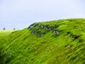 Polonyna Runa, Transcarpathian region. Mountains in spring and summer. Green hills and blue sky. Rocks and ruins in nature. Royalty Free Stock Photo