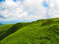 Polonyna Runa, Transcarpathian region. Mountains in spring and summer. Green hills and blue sky. Rocks and ruins in nature. Royalty Free Stock Photo