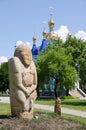 Polovtsian stone sculpture in the background of the Orthodox Church Royalty Free Stock Photo