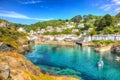 Polperro Cornwall England uk with clear blue and turquoise sea in vivid colour HDR like painting Royalty Free Stock Photo