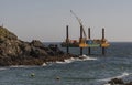 Offshore work platform. Covering a submerge outfall pipe with concrete. Cornwall, UK Royalty Free Stock Photo