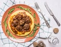 Polpetini beef with polenta on a plate with leaves arugula, white cloth, spices and vintage cutlery top view close up Royalty Free Stock Photo