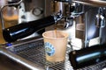 Fresh coffee is poured into a plastic glass