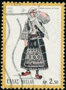 Vintage stamp printed in Greece 1972 shows woman in folk costume