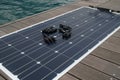 Polycrystalline flexible solar panel and mc 4 connectors on the background on the teak deck of the bert