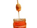 Polyflora bee honey flowing into a jar from a wooden spoon. The concept of beekeeping Royalty Free Stock Photo