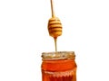 Polyflora bee honey flowing into a jar from a wooden spoon. The concept of beekeeping Royalty Free Stock Photo