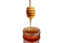 Polyflora bee honey flowing into a jar from a wooden spoon. The concept of beekeeping Royalty Free Stock Photo